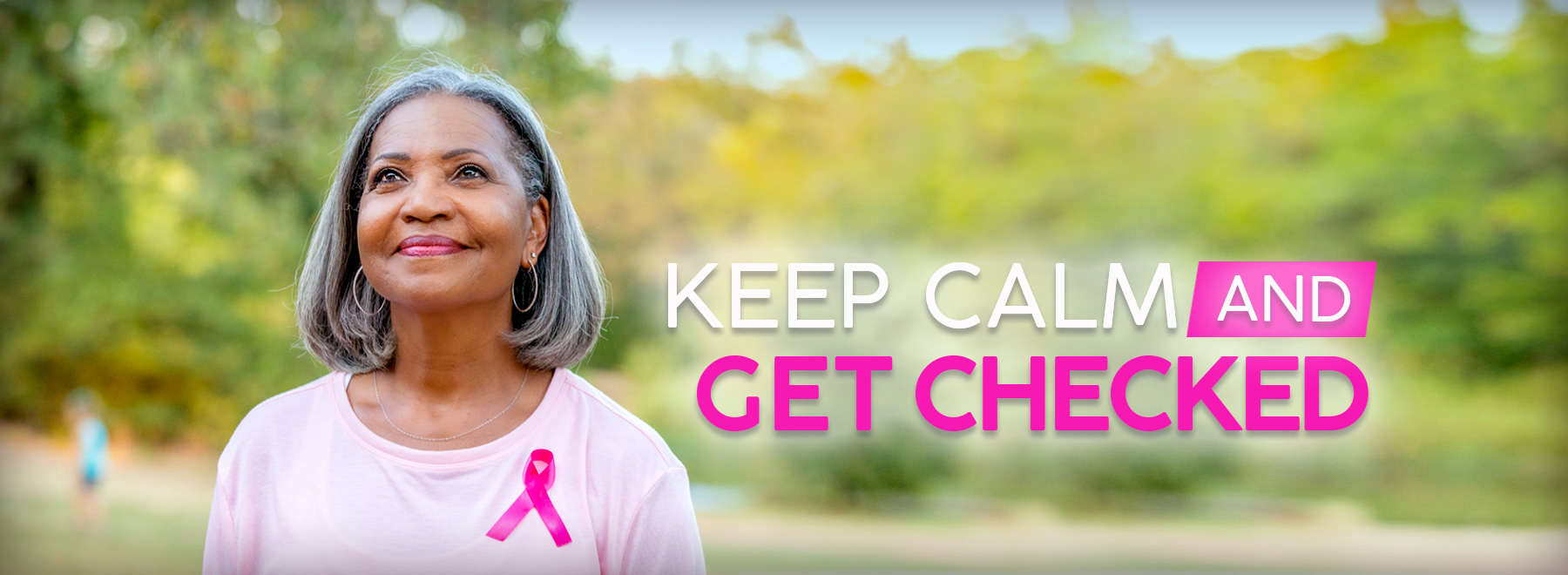 African American woman with a pink shirt and pink breast cancer survivor ribbon